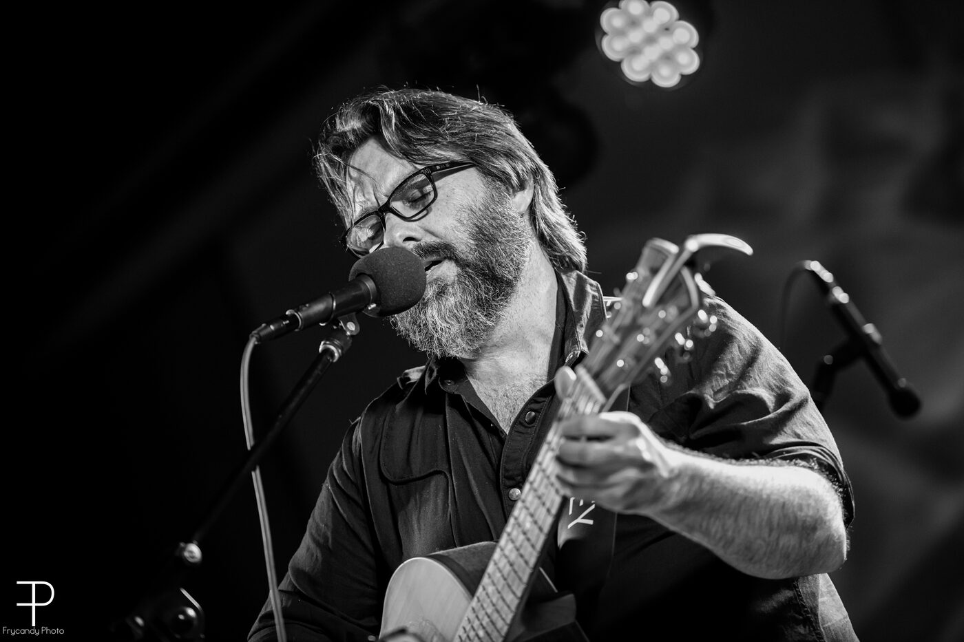 AJ Patrick performing with an acoustic guitar