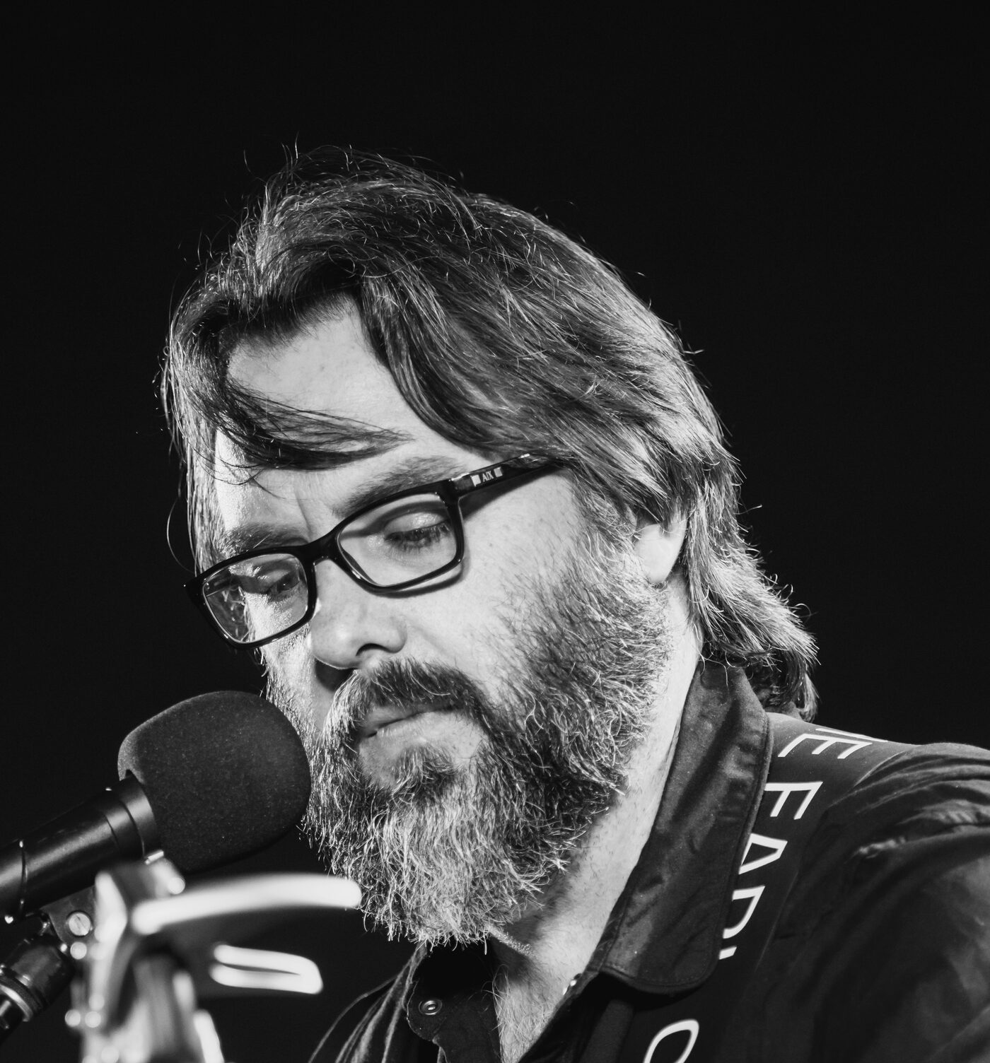 AJ Patrick singing at a microphone